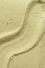 Obraz premium close up of textured sand background, beautiful sand texture, overhead view of sand, pattern drawn in the sand, Top view of fine grain texture