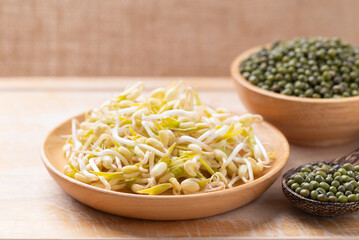Mung bean sprouts and seeds on wooden background, Food ingredient in Asian cuisine
