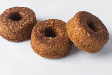 close up view of mini vanilla cakes on a white countertop, mini vanilla bundt cakes on a white background