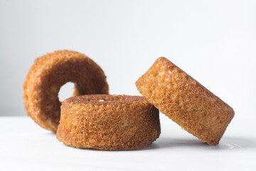 close up view of mini vanilla cakes on a white countertop, mini vanilla bundt cakes on a white background