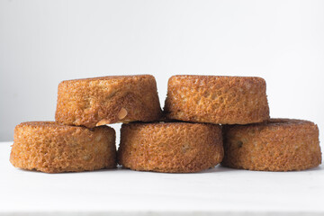 close up view of mini vanilla cakes on a white countertop, mini vanilla bundt cakes on a white background