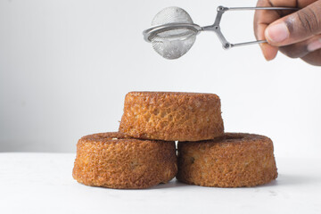 close up view of mini vanilla cakes on a white countertop, mini vanilla bundt cakes on a white background