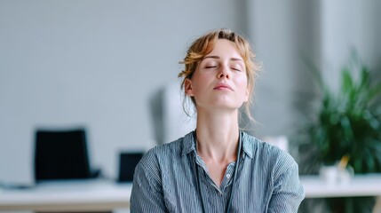 Serene businesswoman practicing mindfulness in modern office, finding inner peace and focus, ideal for wellness programs and stress management content