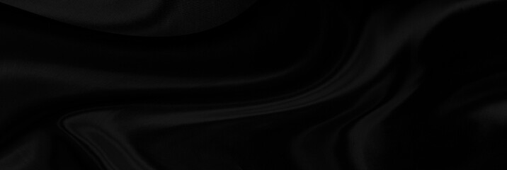 Black gray satin dark fabric texture luxurious shiny that is abstract silk cloth panorama background with patterns soft waves blur beautiful.