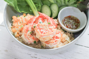 Shrimp fried rice with various vegetable and fish sauce chili on white table. Homemade Asian food style.