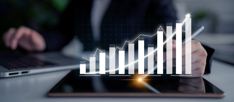 A business professional engages with data trends on a tablet, showcasing digital graphs and charts that highlight growth and strategic progress in a contemporary office setting. Impute
