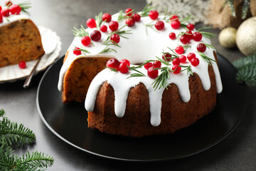 Tasty cake with cranberries and Christmas decor on grey table, closeup