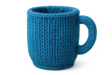 Blue knitted mug cozy keeping a ceramic cup warm and comfortable, concept of handmade craft and winter drinks