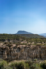 Tabernas desert showing arid landscape with mountains and eroded canyons under clear sky in Andalusia, Spain