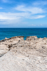 Los Escullos Beach showing rugged rock formations meeting the deep blue ocean in Cabo de Gata, Spain