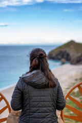 Woman admiring scenic Playa de los Muertos in Almeria, Spain