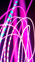 The winding light trails, resembling lightning, stretch from red to yellow and bright green in the...