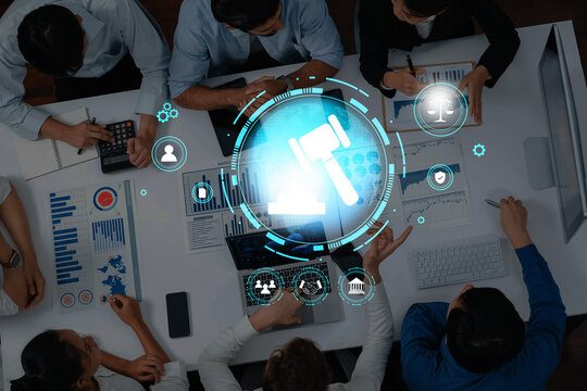 A dynamic business meeting showcasing collaboration with data analysis, financial reports, and legal concepts in a modern office setting, emphasizing teamwork and technology. Trope - Powered by Adobe