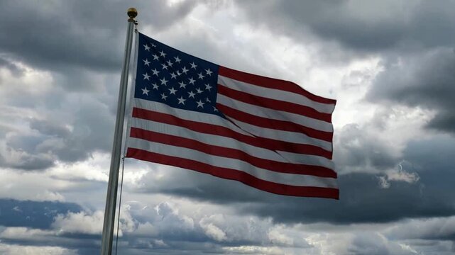 USA flag waving against a dark stormy sky with lightning flashes. Concept of national resilience, political turmoil, crisis, and American patriotism facing difficult challenges. - Powered by Adobe