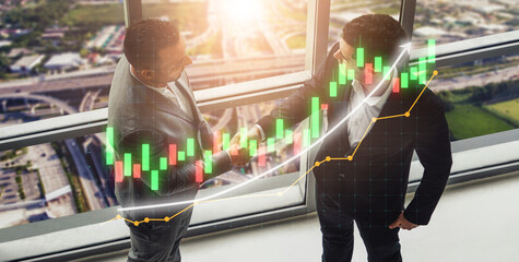 Two businessmen shaking hands in a modern office, with a stock market graph overlay representing financial growth, teamwork, and successful partnerships. Impute