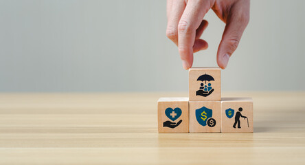Insurance and financial planning concept with wooden blocks showing savings, retirement, health, protection, and investment icons, symbolizing risk management, wealth security, financial stability