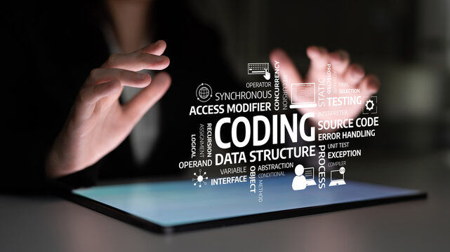 A software developer uses a tablet to explore key coding concepts and terminology, showcasing the dynamic nature of modern technology and programming education. Tessel