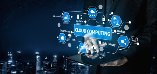 A businessman interacts with a digital tablet displaying cloud computing icons, emphasizing data management, security solutions, and modern technology trends in business. Tessel