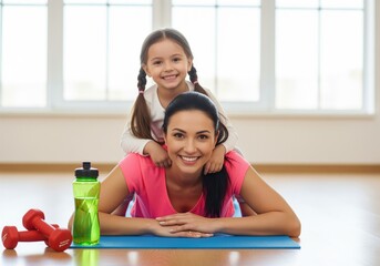 Happy mother and daughter smiling during a fun fitness session on mat