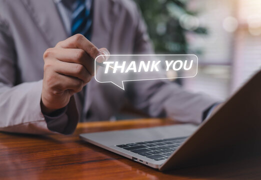 A businessman holding a glowing “THANK YOU” speech bubble, symbolizing appreciation, positive communication, customer relations, gratitude messaging, and professional interaction in modern business.