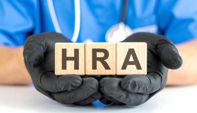 Doctor holding wooden blcoks sess the abbreviation HRA. HRA - Health Reimbursement Arrangement Medical Concept doctor holding a sign