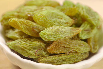 Green Xinjiang Raisins with Three Colors Toffee Highlights in White Bowl