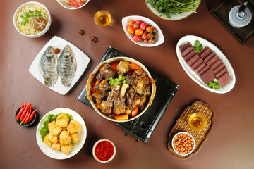 Asian Hot Pot Lamb Stew with Fish and Side Dishes Traditional Feast Table Setting