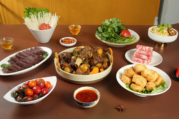 Chinese Hot Pot Feast with Lamb, Vegetables and Noodles on Wooden Table