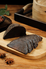 Fresh Black Bread Slices on Wooden Board with Spices and Traditional Kitchen Setup