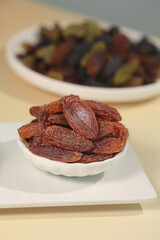 Red Xinjiang Raisins in Bowl with Mixed Dried Fruits Background - Healthy Organic Snacks