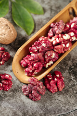 Red Xinjiang Walnuts in Wooden Scoop - Fresh Organic Nuts on Rustic Wood Background