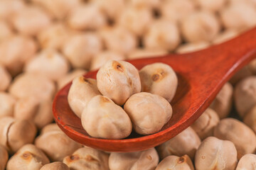 Fried Salted Chickpeas on Red Wooden Spoon - Traditional Xinjiang Variety Snack with Golden Crispness