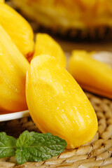 Fresh Hainan Honey Pineapple Slices from Thailand with Golden Yellow Flesh on Woven Basket