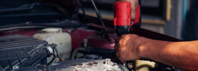 Banner Close up Mechanic man hands repairing car auto repair shop. Banner Man hands fixing machinery check vehicle mechanical motor service. Vehicle Car overhaul maintenance engineer with copy space