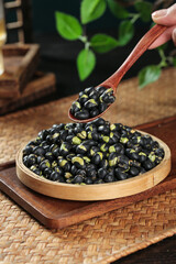 Crispy Fried Black Beans with Salt and Spice in Wooden Spoon - Healthy Asian Snack Food