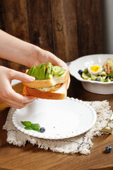Fresh Avocado Toast with Egg - Healthy Breakfast Choice on Rustic Wooden Table