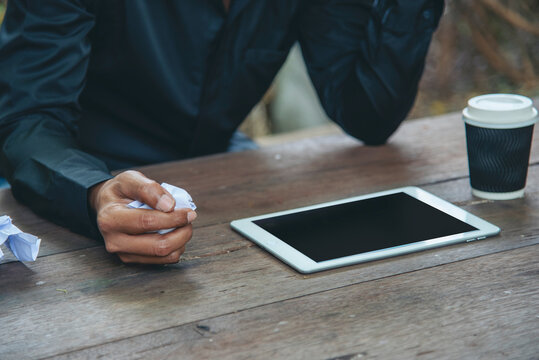 Man hands writing notebook diary with coffee cup and smartphone on wood desk. Close up man hands using pen sitting at wooden table outdoors lifestyle. Men write planner note diary office agenda - Powered by Adobe