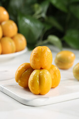 Fresh Ripe Apricots on White Cutting Board with Natural Green Background