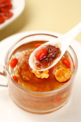Herbal corn silk tea with goji berries in glass mug - healthy nutrition brew with natural ingredients