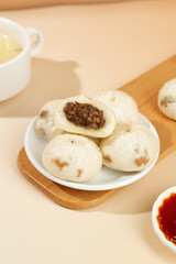 Traditional Chinese Xiao Long Bao Steamed Pork Buns with Preserved Vegetables and Tea