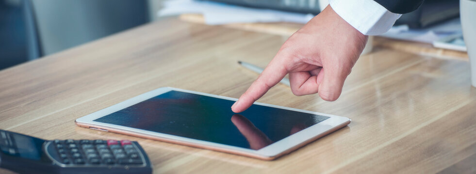 Banner Closeup businessman hands working use laptop finance business document reading report paperwork office desk. Banner Man hands type keyboard write on office note touch screen with copy space - Powered by Adobe