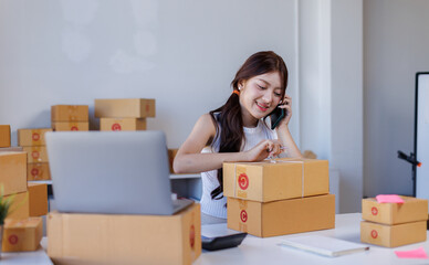 Fototapeta premium Business woman young postal worker is suffering from a headache and is sitting at her desk full of packages 