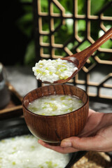 Fresh Green Congee Rice Porridge in Wooden Bowl - Healthy Asian Cuisine Showcase