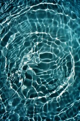 Blue water with ripples on the surface. Defocus blurred transparent blue colored clear calm water surface texture with splashes and bubbles. Water waves with shining pattern texture background.