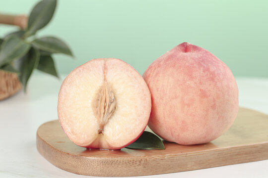 Fresh Summer Peaches on Wooden Board - Ripe Fruit Cut in Half Showing Juicy Flesh