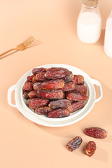 Golden UAE Dates in White Bowl with Milk - Traditional Middle Eastern Dried Fruits on Warm Background