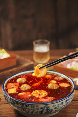 Hot Spicy Asian Meatball Soup with Chopsticks in Traditional Bowl - Authentic Asian Cuisine