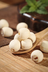 Dried White Lotus Seeds on Wooden Spoon - Traditional Asian Nourishing Ingredients with Natural Heart-Shaped Patterning