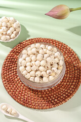 Dried White Lotus Seeds in Glass Bowl with Pink Lotus Flower - Healthy Asian Superfood Ingredients