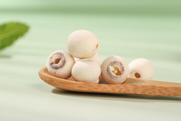 Dried White Lotus Seeds on Wooden Spoon - Nutritious Asian Superfood Ingredients for Healthy Cooking